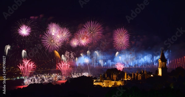 Fototapeta Light show on the Bosphorus Bridge with fireworks and night lights on Topkapi Palace Istanbul