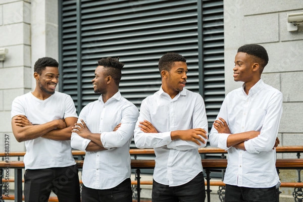 Fototapeta four handsome young african men in white shirts