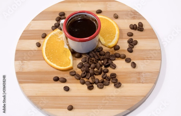 Fototapeta cup of coffee and beans on wooden table