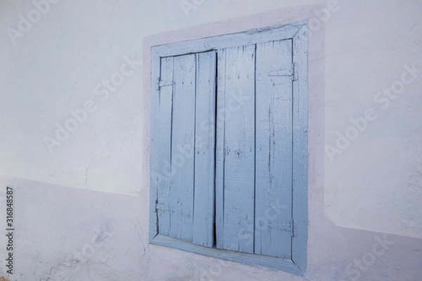 Obraz closed blue colored wooden window blinds of a house