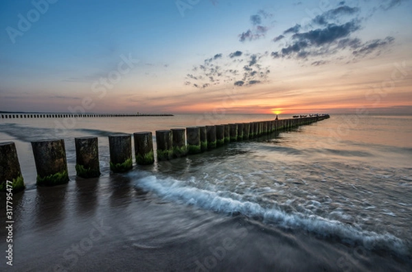 Fototapeta Baltic sea seascape at sunset, Poland, wooden breakwater and waves