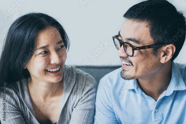 Fototapeta couple love concept.asian sweet lover man and women smiling taking a selfie sitting on sofa at home on anniversary hug in embrance each other.photo of people smile enjoy  Beautiful romantic time