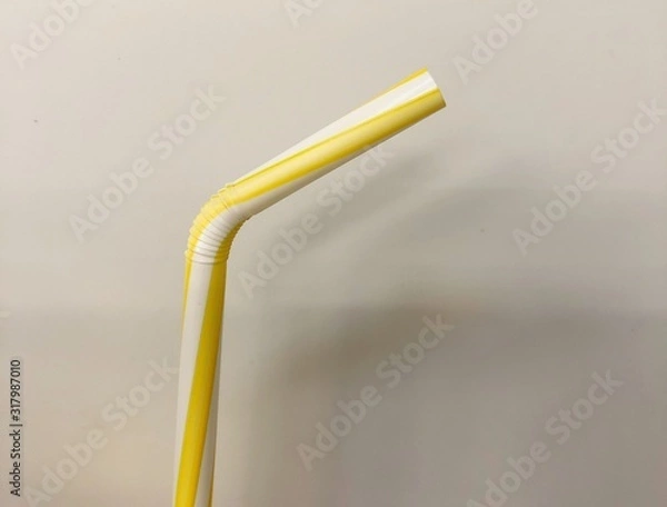 Fototapeta Drinking straw yellow tube isolated on white background