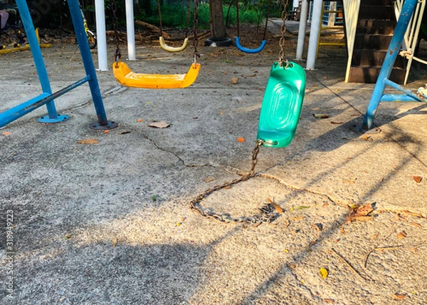 Fototapeta Broken chain swing in playground