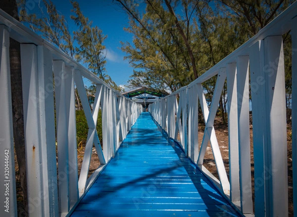 Fototapeta Floating Wooden Bridge Leading Toward The Beach