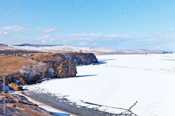 Fototapeta Baikal Lake. Olkhon Iisland in early spring. View from Cape Burhan to the village of Khuzhir on an April sunny day. Change of seasons. Natural background