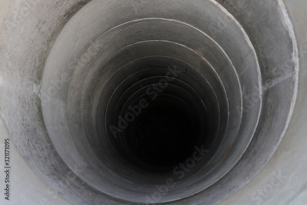 Fototapeta pulling out bucket full of drink water from the well, view of the water well, scooping water with buckets from water well