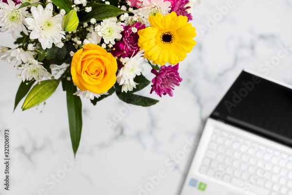 Fototapeta flowers and notebook on light gray background