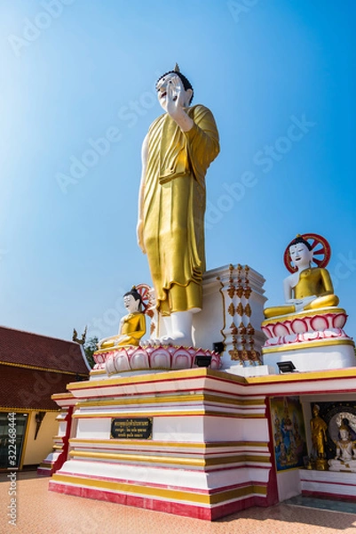 Fototapeta Chiang Mai , Thailand - January, 17, 2020 : Buddha statue, Big standing Buddha statue at Wat Phra That Doi Kham in Chiang Mai, Thailand