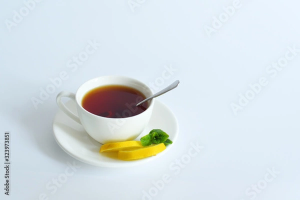 Fototapeta One small cup of tea with mint and lemon.