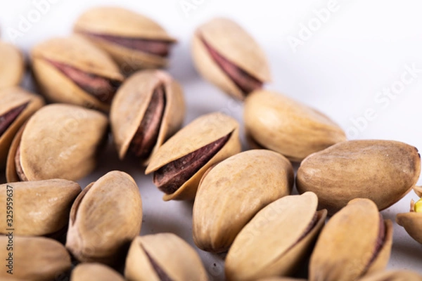 Fototapeta Pistachios isolated on a white background. 