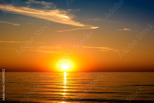 Fototapeta beautifun sunset on the beach with calm sea