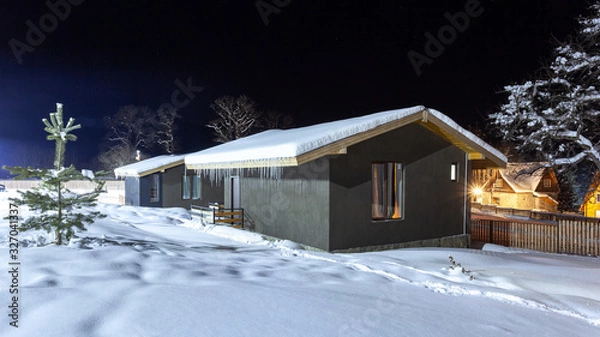 Fototapeta Cottages in the winter resort of Bakuriani at night