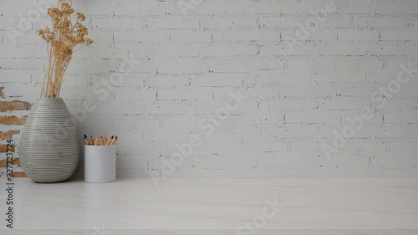 Fototapeta Close up view of minimal copy space with  coloured pencils and ceramic vase on marble desk