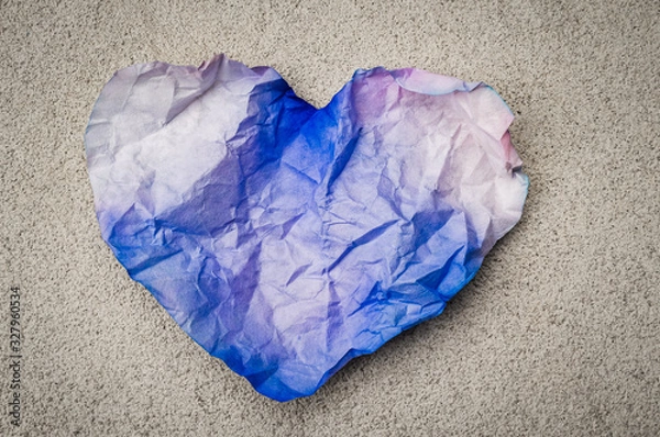 Fototapeta Crumpled paper heart shape on the ground