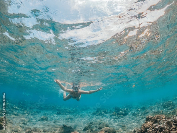 Fototapeta Woman snorkeling in the sea, Lipah beach, Amed, Bali.