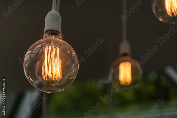 Fototapeta Vintage antique hanging light bulbs. Holidays and business good idea concept.