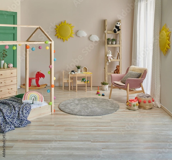 Fototapeta Decorative child room with wooden bed cabinet and pink chair interior decor.