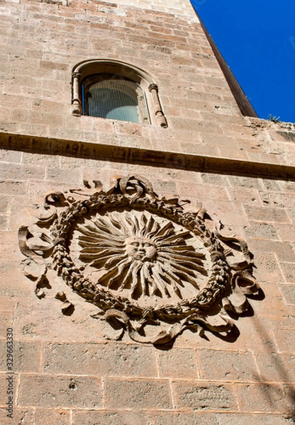 Fototapeta Almeria Cathedral, Spain. High on the wall is a sun emblem, known by locals as the Sol de Portocarrero. It is the symbol of city of Almeria.