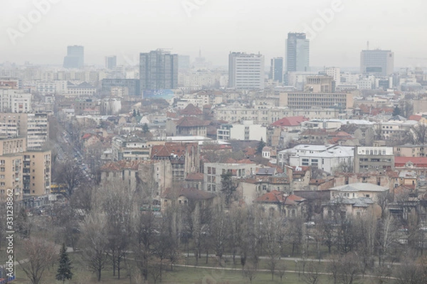 Fototapeta Overview of Bucharest as seen from the Palace of Parliament on a cloudy day.