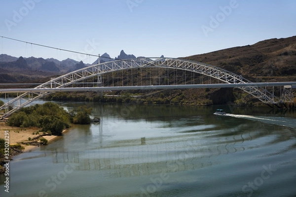 Fototapeta Bridge crossing Colorado River with turquoise color water from Needles California into Arizona