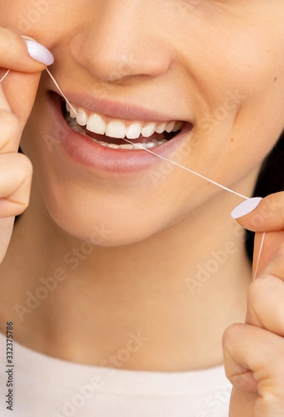 Fototapeta dental floss with a smile and beautiful teeth. flossing