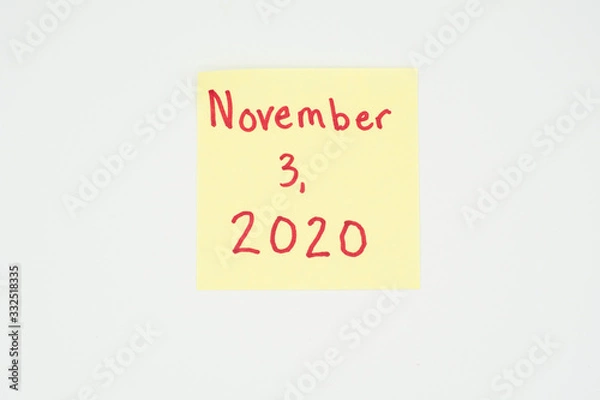 Fototapeta November 3, 2020 written on a yellow sticky note with copyspace. Presidential election 2020