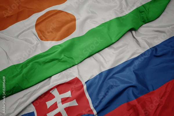 Fototapeta waving colorful flag of slovakia and national flag of niger.