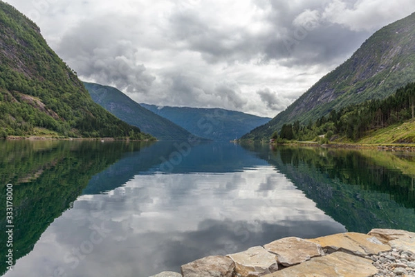 Fototapeta End of fjord. Beautiful Norwegian landscape. view of the fjords. Norway ideal fjord reflection in clear water In cloudy weather. selective focus