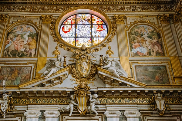 Fototapeta Rich ornate interior detail of church, golden decoration of the walls.