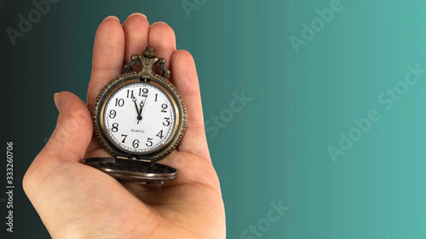 Fototapeta 5 minutes to 12 o'clock. Old pocket watch in young woman's hand. Copy space area for text. 