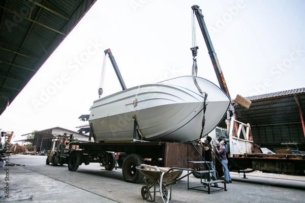 Fototapeta Pulling boat up with crane