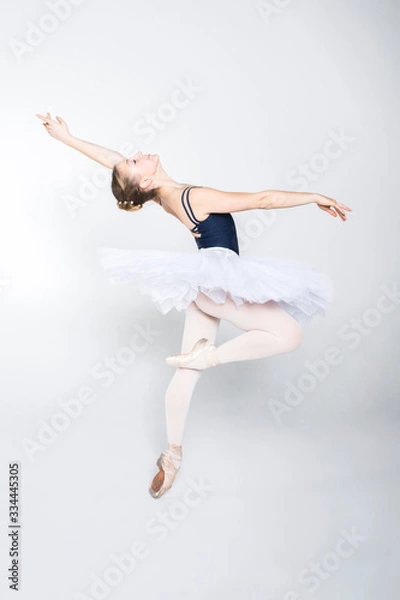 Fototapeta Young ballerina practising ballet moves