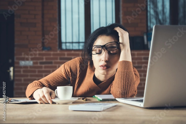 Fototapeta tired woman in office table