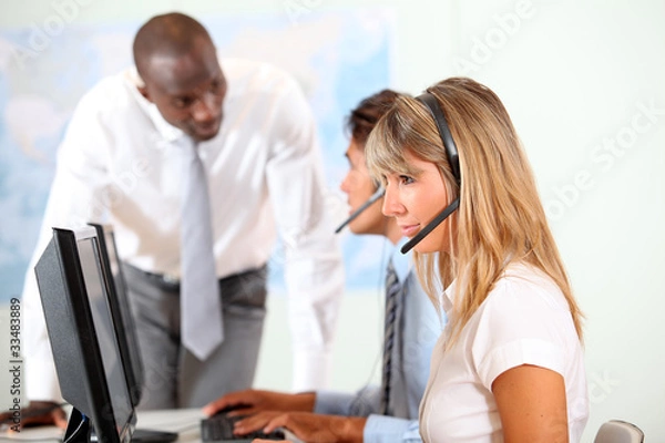 Fototapeta Office people working in front of helpdesk