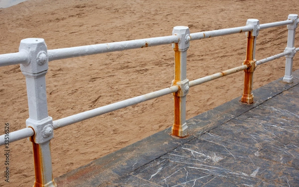 Fototapeta Rusty railing on the beach