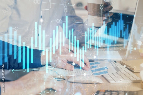 Fototapeta Multi exposure of chart with man typing on computer in office on background. Concept of hard work.