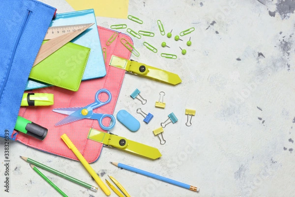 Fototapeta School backpack and stationery on light background