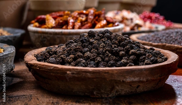 Fototapeta Indian spices collection, dried black peppercorns  and another spices in clay bowls