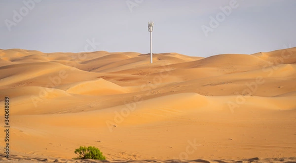 Fototapeta a mobile tower standing in between sand dunes at Liwa desert, Liwa desert, Moreeb dunes Liwa, Liwa motor festival, empty quarter