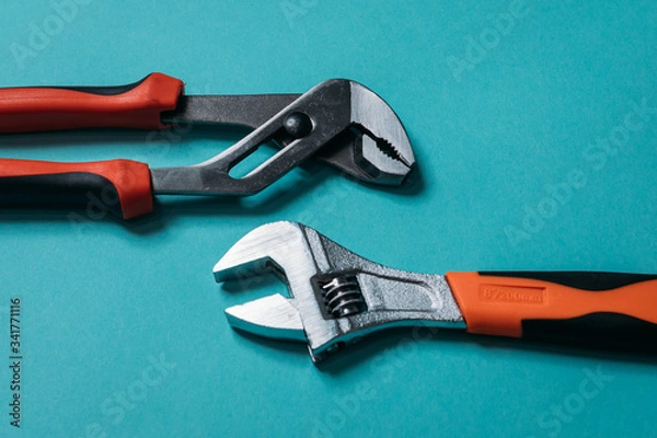 Obraz metal pliers of metal on a blue background laid neatly close