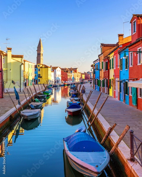 Fototapeta Street with colorful buildings in Burano island, Venice, Italy. Architecture and landmarks of Burano, Venice postcard. Scenic canal and colorful architecture in Burano island near Venice, Italy