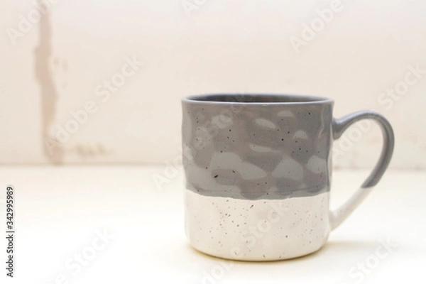 Fototapeta Gray ceramic mug on concrete wall background