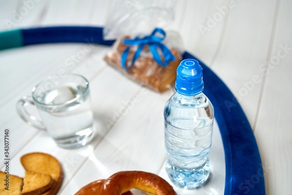 Fototapeta A bottle of water, crackers, drying on the background of boards for a healthy lifestyle.