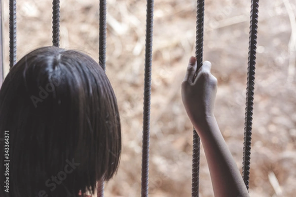 Fototapeta child holding cage, Human trafficking concept, human rights violations,