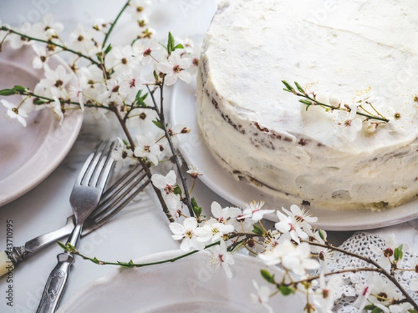 Fototapeta Flowering tree and fresh, homemade cake. Close-up, view from above, outdoors