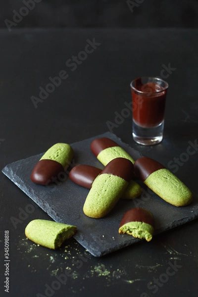 Fototapeta Chocolate Dipped Matcha Tea Butter Cookies, on a dark background.