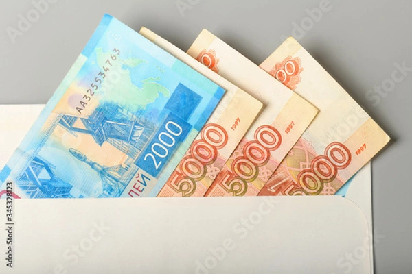 Fototapeta Cash notes in a white postal envelope. Russian money in a postal envelope. Bills in an envelope.