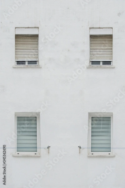 Fototapeta white facade with four symmetrical windows