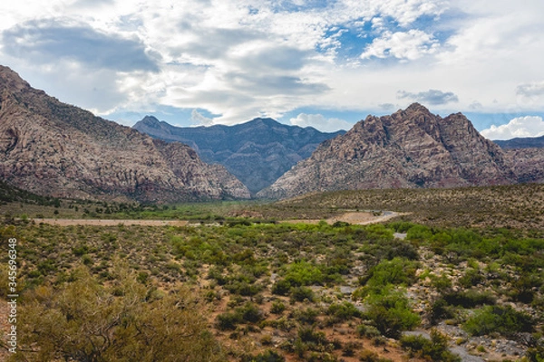 Fototapeta The desert environment inside Red Rock Canyon State Park in Las Vegas, Nevada, USA with storm clouds brewing overhead.